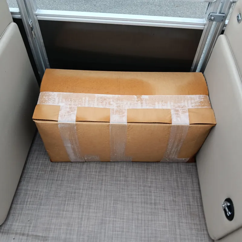 Slide: The Image of Cardboard box on Sun Tracker Party Barge 20 DLX, 2025 model, interior view. - 14