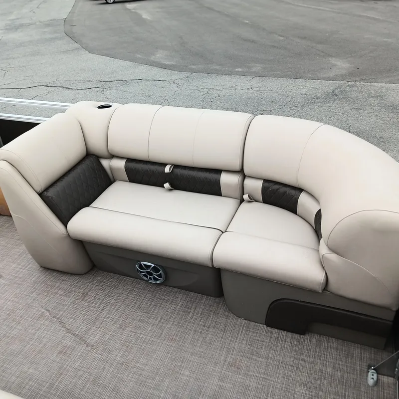 Slide: The Image of 2025 Sun Tracker Party Barge 20 DLX pontoon seating with beige and black upholstery. - 7