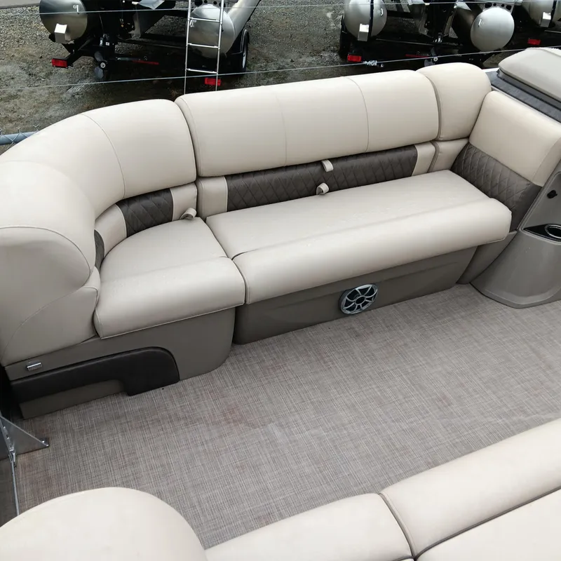 Slide: The Image of 2025 Sun Tracker Party Barge 20 DLX interior seating with beige upholstery. - 8