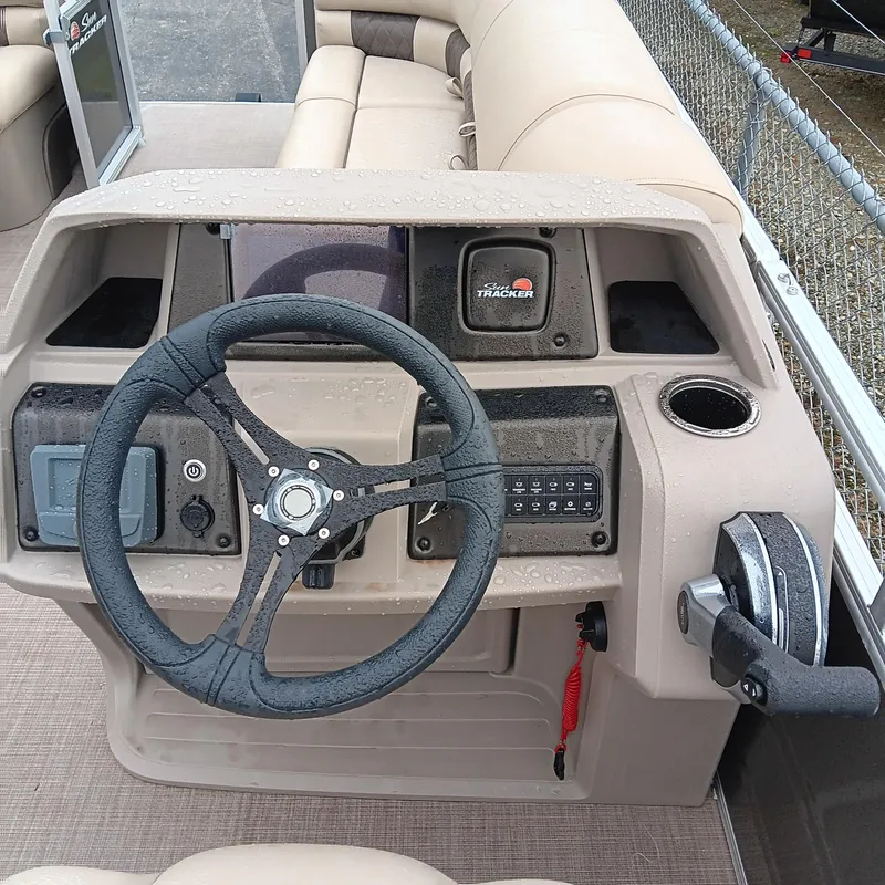 Slide: The Image of 2025 Sun Tracker Party Barge 20 DLX steering console with controls and seating. - 9