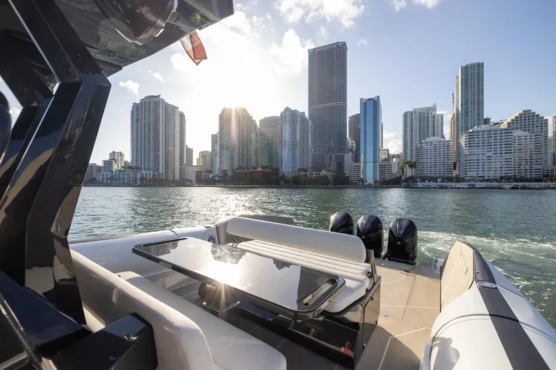 Slide: The Image of 2025 Anvera 42 Speedster yacht cruising near city skyline at sunset. - 11