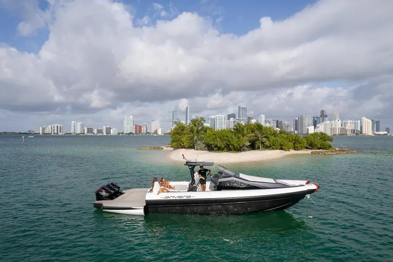 Slide: The Image of 2025 Anvera 42 Speedster boat near a small island with city skyline in the background. - 16