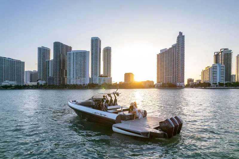 Slide: The Image of 2025 Anvera 42 Speedster boat cruising near city skyline at sunset. - 2
