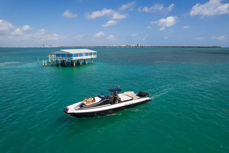 Slide: The Image of 2025 Anvera 42 Speedster cruising near a stilt house on turquoise waters. - 27