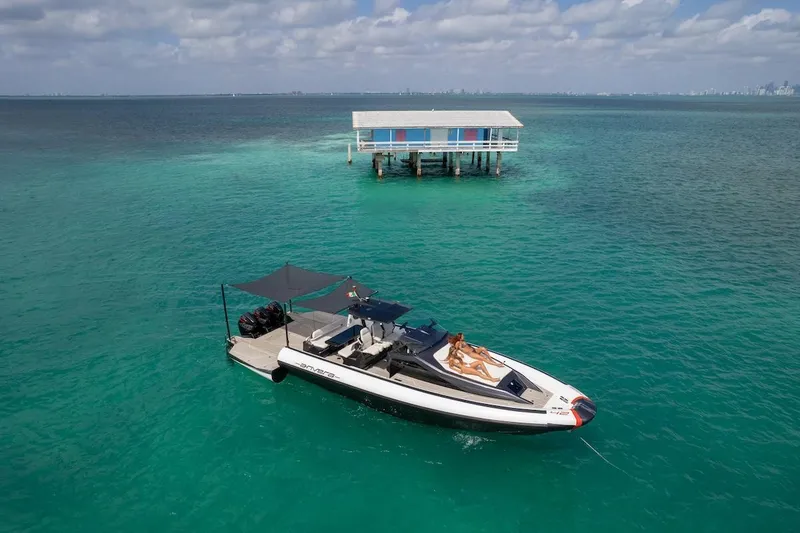Slide: The Image of 2025 Anvera 42 Speedster yacht anchored near a stilt house on turquoise water. - 3