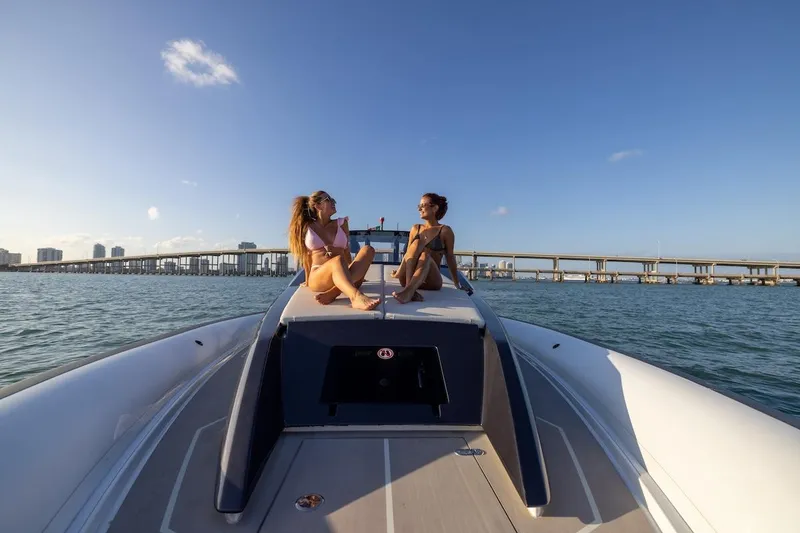 Slide: The Image of Two people relaxing on a 2025 Anvera 42 Speedster boat in sunny waters. - 5