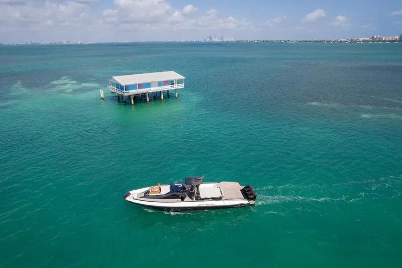 Slide: The Image of 2025 Anvera 42 Speedster cruising near a stilt house on turquoise waters. - 8