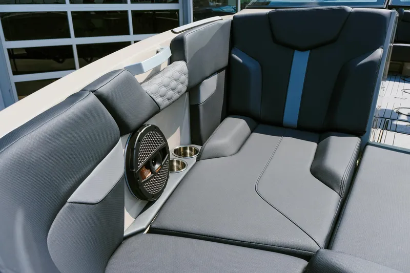 Slide: The Image of 2025 MasterCraft XT24 boat interior with sleek gray seating and built-in speaker system. - 15