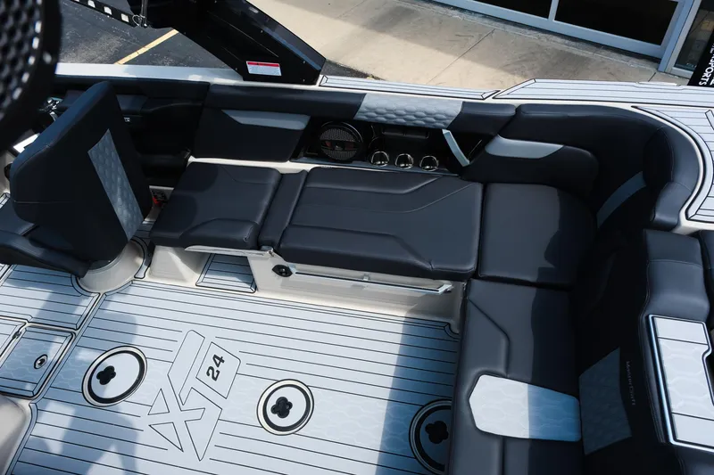 Slide: The Image of 2025 MasterCraft XT24 boat interior with sleek black seating and modern design elements. - 21