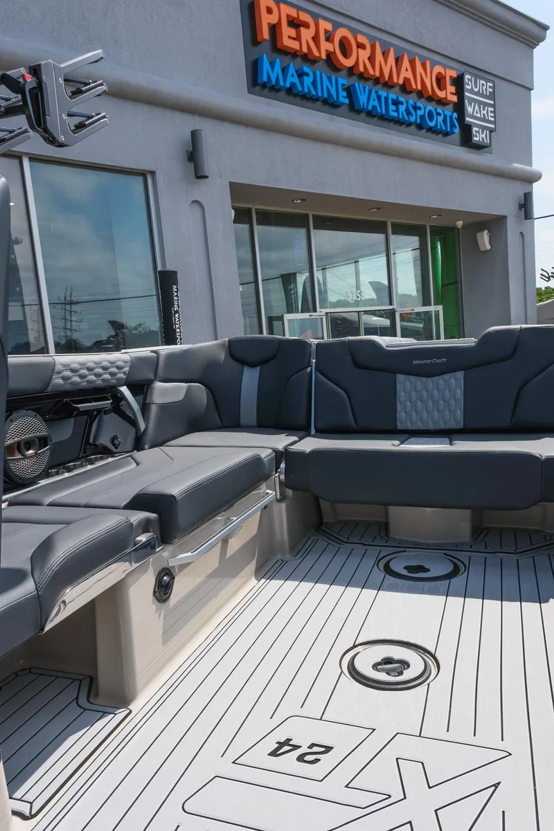Slide: The Image of 2025 MasterCraft XT24 boat interior at Performance Marine Watersports dealership. - 24