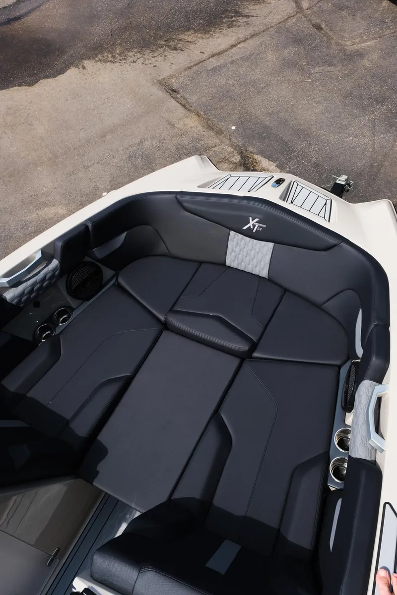 Slide: The Image of 2025 MasterCraft XT24 boat interior with sleek black seating and modern design. - 31