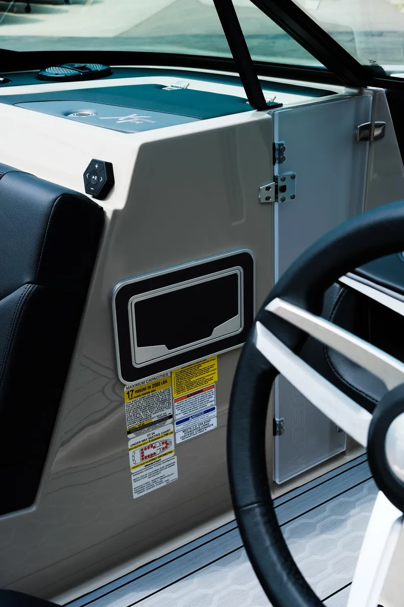 Slide: The Image of 2025 MasterCraft XT24 boat interior with steering wheel and control panel. - 35