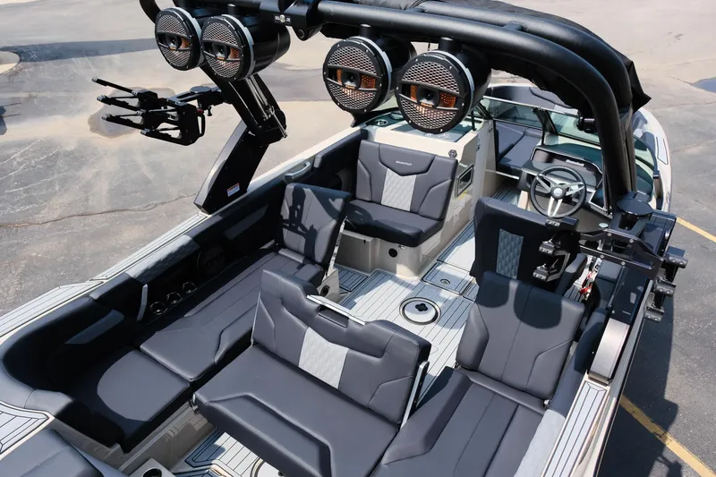 Slide: The Image of 2025 MasterCraft XT24 boat interior with sleek seating and advanced audio system. - 37