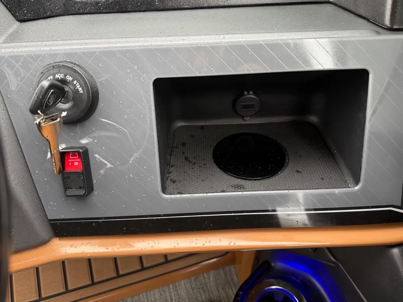 Slide: The Image of 2025 Tahoe Pontoon Grand Tahoe LTD dashboard with ignition, switch, and storage compartment. - 14