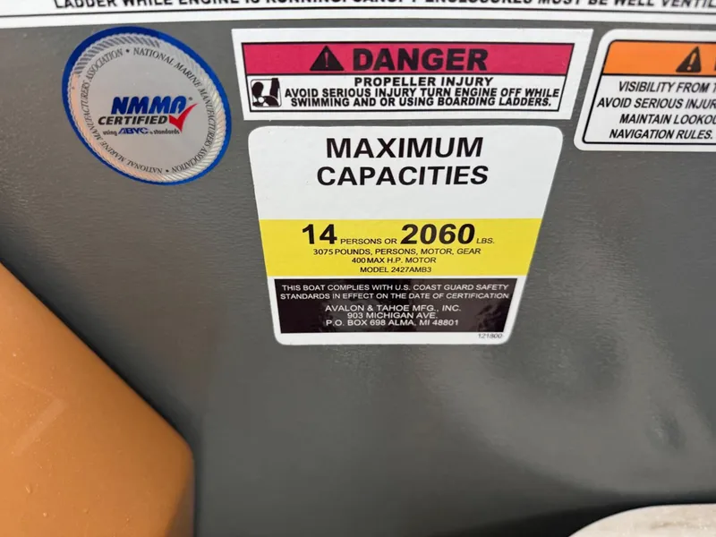 Slide: The Image of 2025 Tahoe Pontoon Grand Tahoe LTD capacity label: 14 persons or 2060 lbs, safety warnings included. - 16
