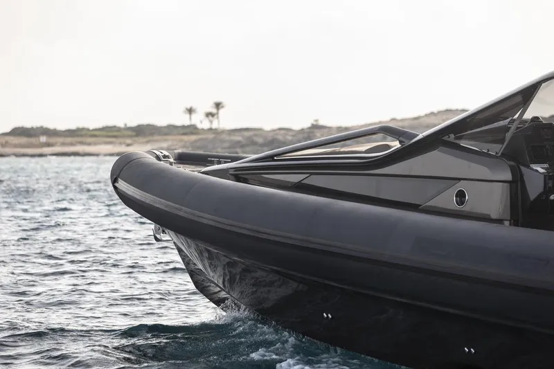 Slide: The Image of Anvera 48 boat cruising on water, 2025 model, sleek black design. - 13