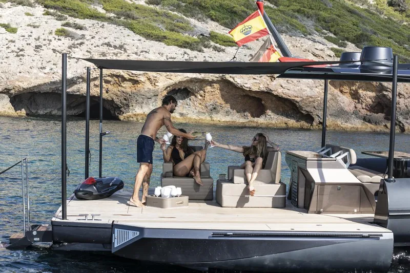 Slide: The Image of 2025 Anvera 48 yacht with people relaxing on deck near rocky coastline. - 15