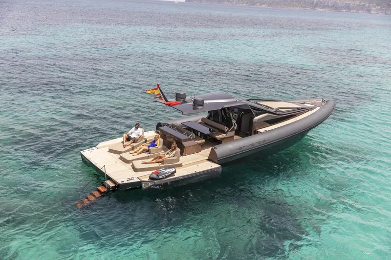 Slide: The Image of Anvera 48 luxury yacht 2025 on clear turquoise water with people relaxing on deck. - 16
