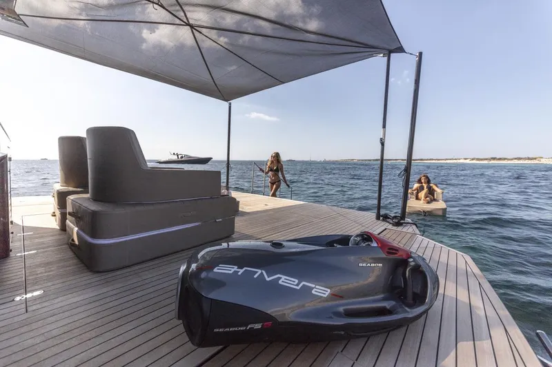 Slide: The Image of Luxury Anvera 48 yacht deck with sea view, featuring modern seating and water activities. - 6