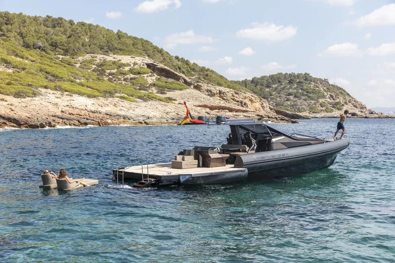 Slide: The Image of Anvera 48 boat cruising near rocky coastline, 2025 model, with people enjoying the water. - 9