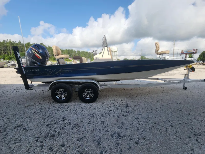 Slide: The Image of 2025 Xpress H22B boat on trailer, parked outdoors under cloudy sky. - 3