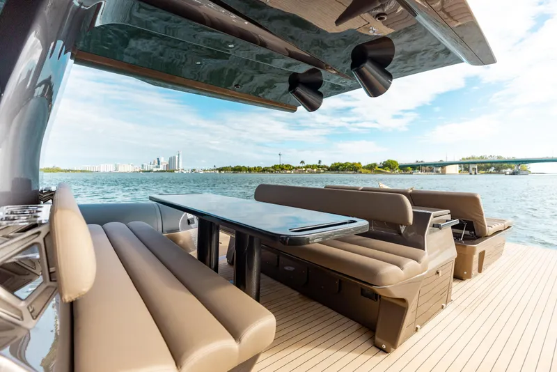 Slide: The Image of Luxurious Anvera 48 yacht deck with seating, table, and scenic waterfront view, 2025 model. - 16