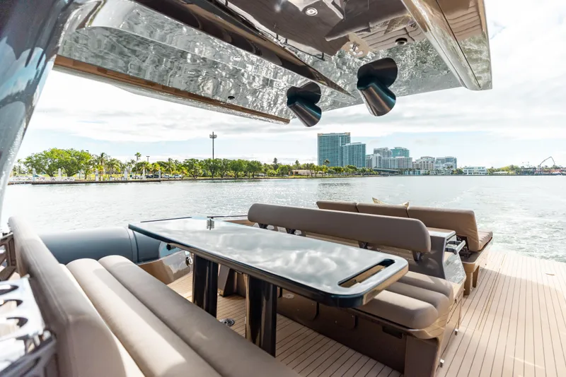 Slide: The Image of Luxurious Anvera 48 yacht interior with sleek seating and table, overlooking scenic waterfront. - 2