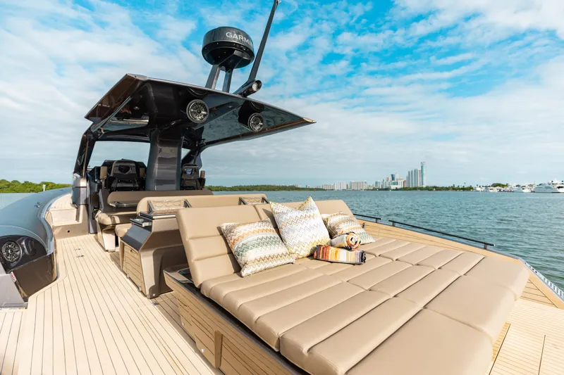 Slide: The Image of Luxurious Anvera 48 yacht deck with sun loungers, cushions, and scenic waterfront view. - 3