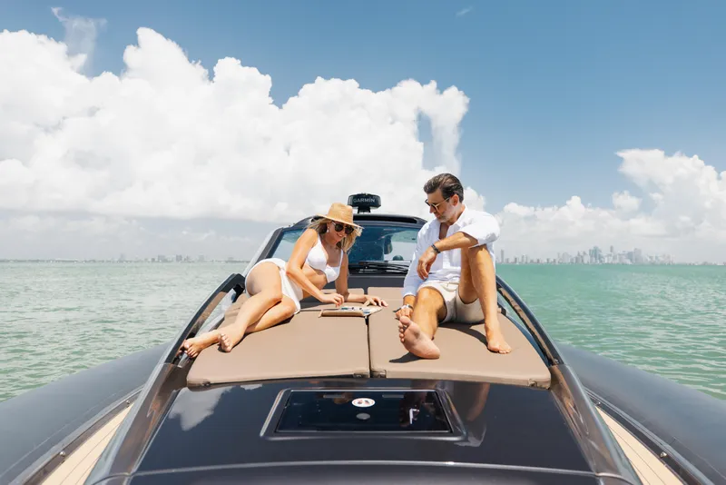 Slide: The Image of Couple relaxing on Anvera 48 yacht, 2025 model, in sunny ocean setting. - 47