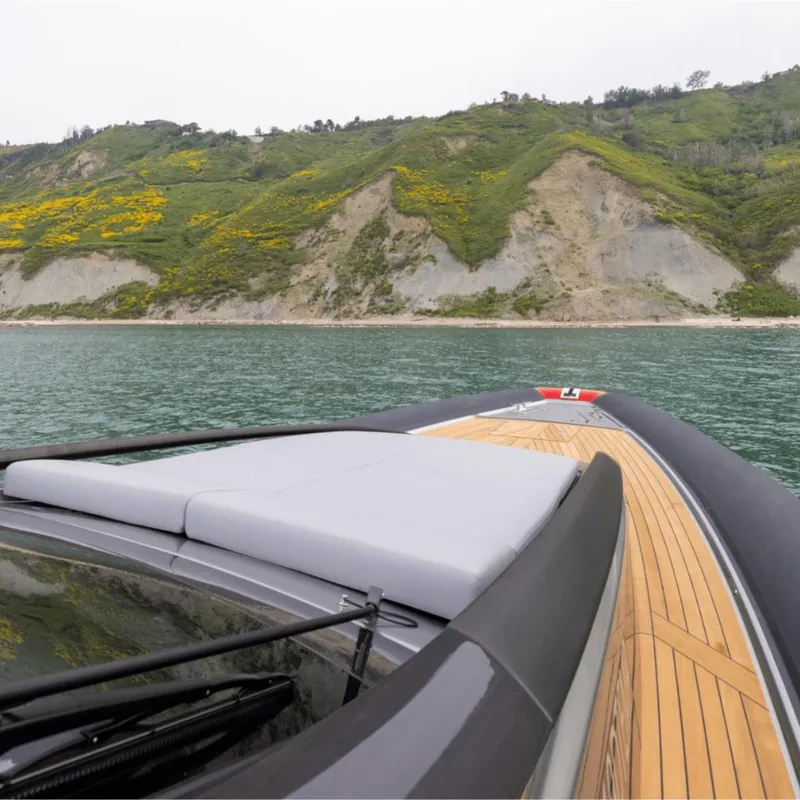 Slide: The Image of Anvera 58 yacht cruising near scenic green cliffs, 2025 model. - 12