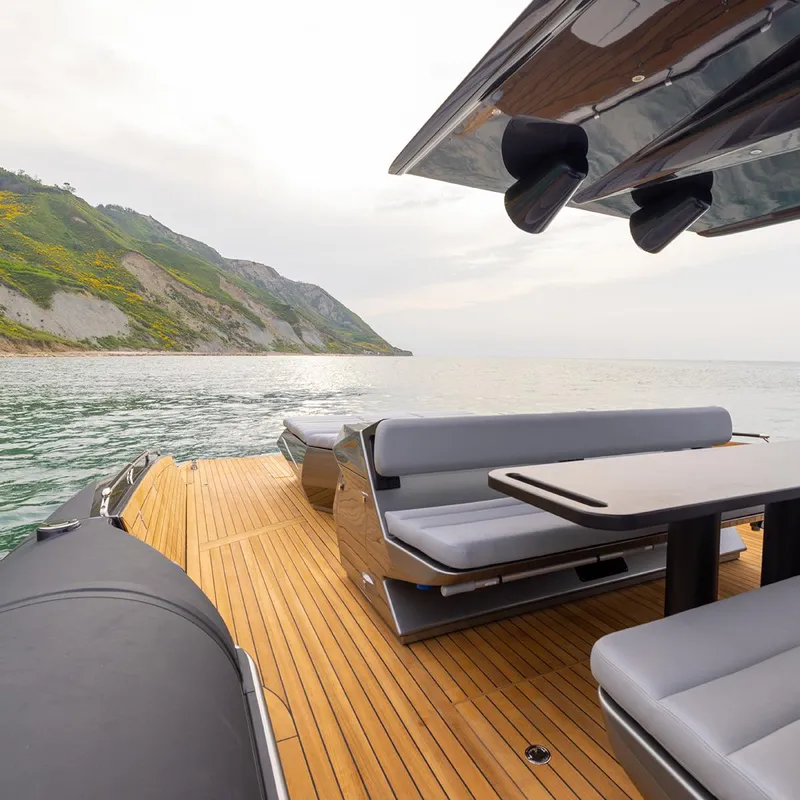Slide: The Image of Luxury Anvera 58 yacht deck with seating, overlooking serene coastal waters, 2025 model. - 6