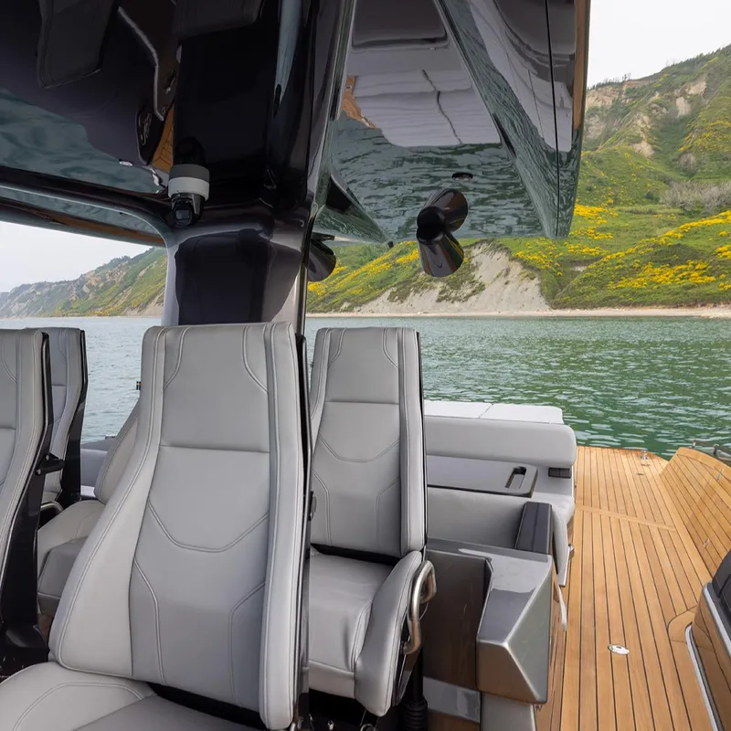Slide: The Image of 2025 Anvera ANVERA 58 luxury yacht interior with sleek seating and scenic coastal backdrop. - 8
