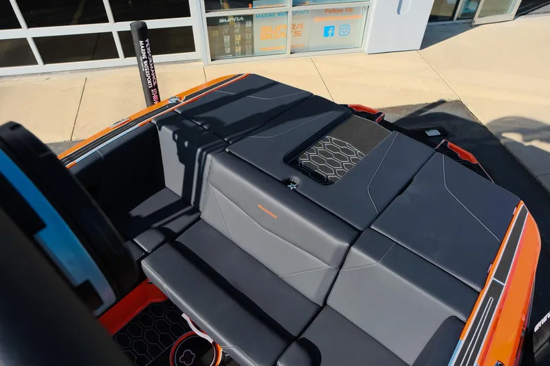 Slide: The Image of 2025 MasterCraft NXT24 boat interior with sleek black seating and modern design. - 14