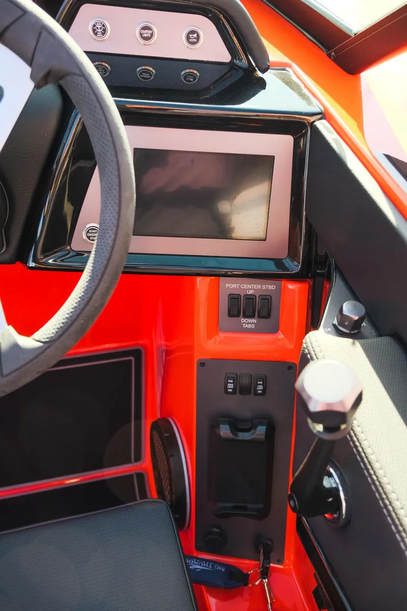 Slide: The Image of 2025 MasterCraft NXT24 boat dashboard with touchscreen and controls. - 18