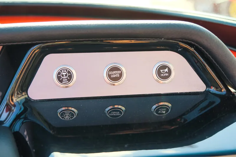 Slide: The Image of Dashboard controls of 2025 MasterCraft NXT24 boat, featuring buttons for lights and horn. - 21
