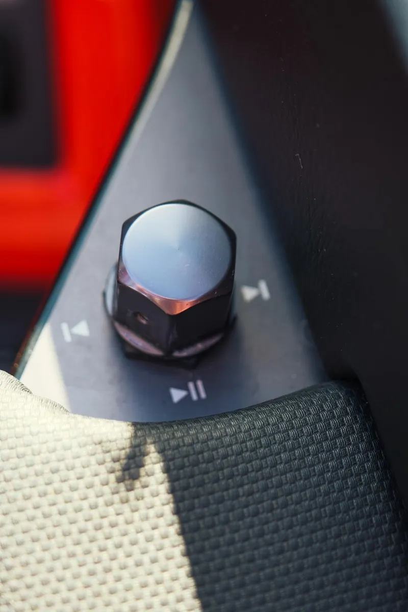 Slide: The Image of Close-up of a 2025 MasterCraft NXT24 control knob with play and skip icons. - 23