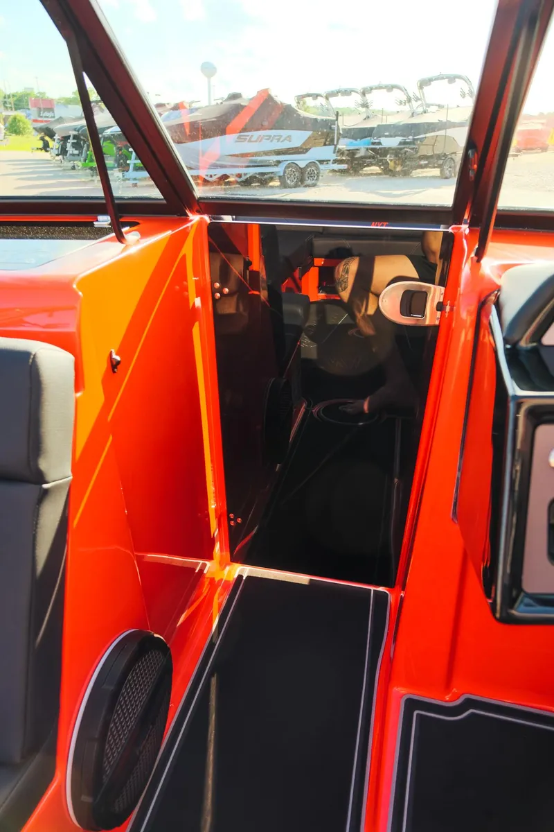 Slide: The Image of 2025 MasterCraft NXT24 boat interior with vibrant orange accents and modern design. - 25