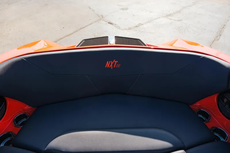 Slide: The Image of 2025 MasterCraft NXT24 boat interior with orange and black seating. - 27