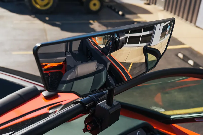 Slide: The Image of Rearview mirror of 2025 MasterCraft NXT24 boat reflecting interior and exterior details. - 30