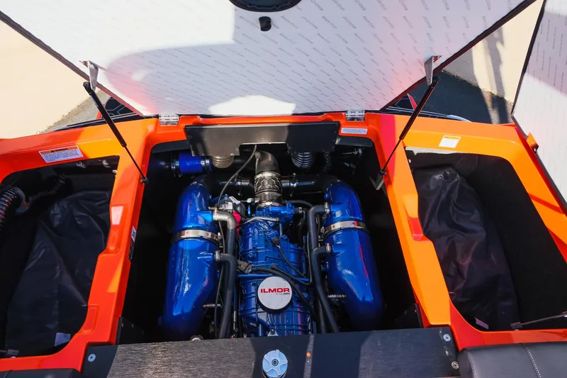 Slide: The Image of 2025 MasterCraft NXT24 engine compartment with Ilmor engine, vibrant orange accents. - 32