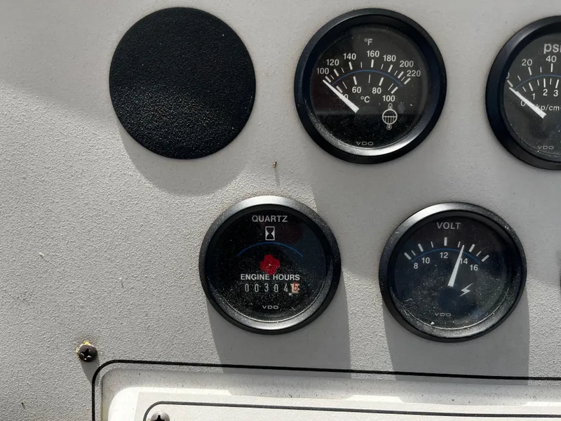 Slide: The Image of Instrument panel of a 1996 Carver 325 Aft Cabin boat showing gauges and engine hours. - 16