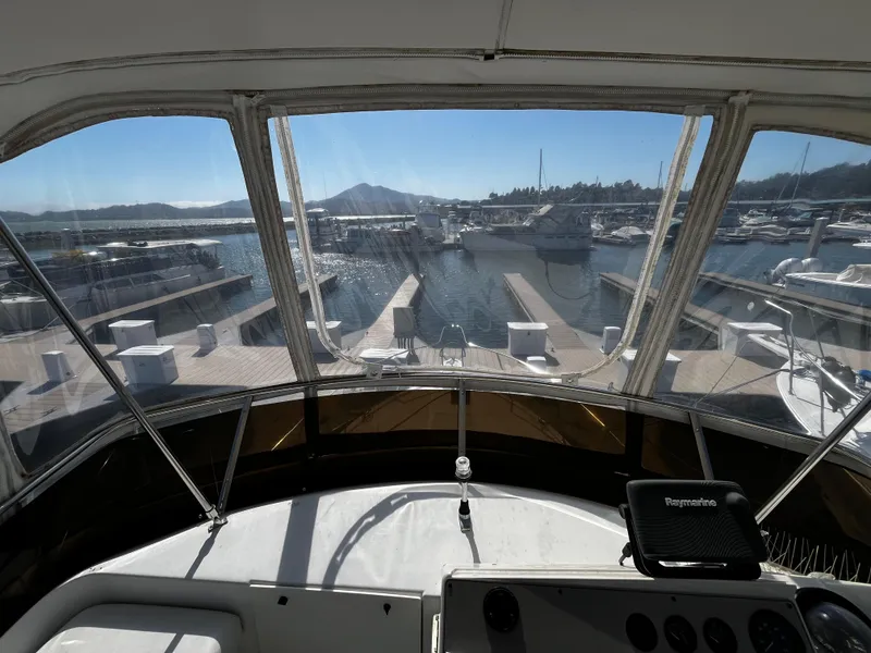 Slide: The Image of 1996 Carver 325 Aft Cabin yacht view from helm, overlooking marina and docks. - 20