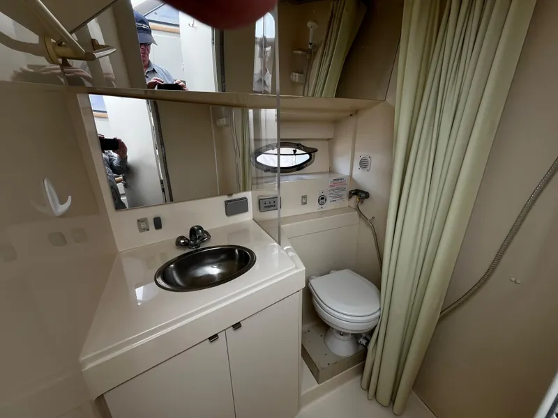 Slide: The Image of Bathroom interior of 1996 Carver 325 Aft Cabin yacht, featuring sink and toilet. - 30