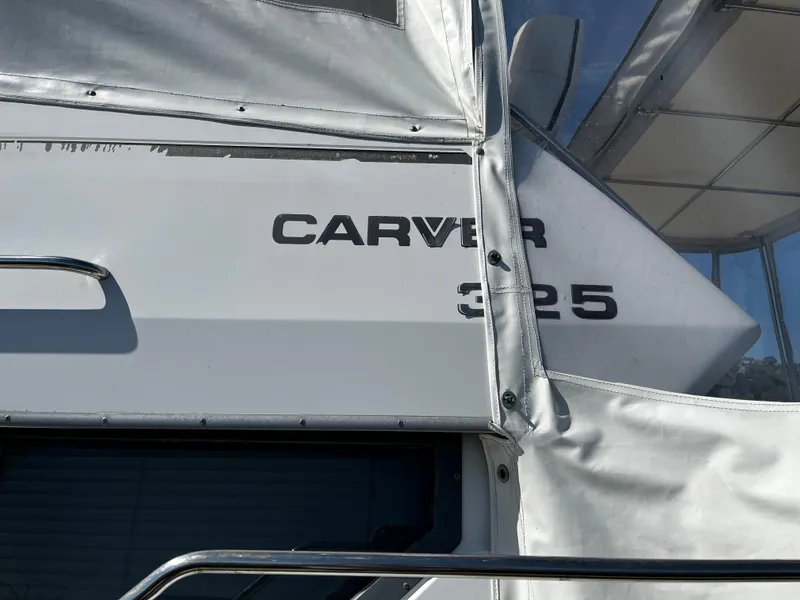 Slide: The Image of 1996 Carver 325 Aft Cabin boat with white exterior and visible branding. - 4