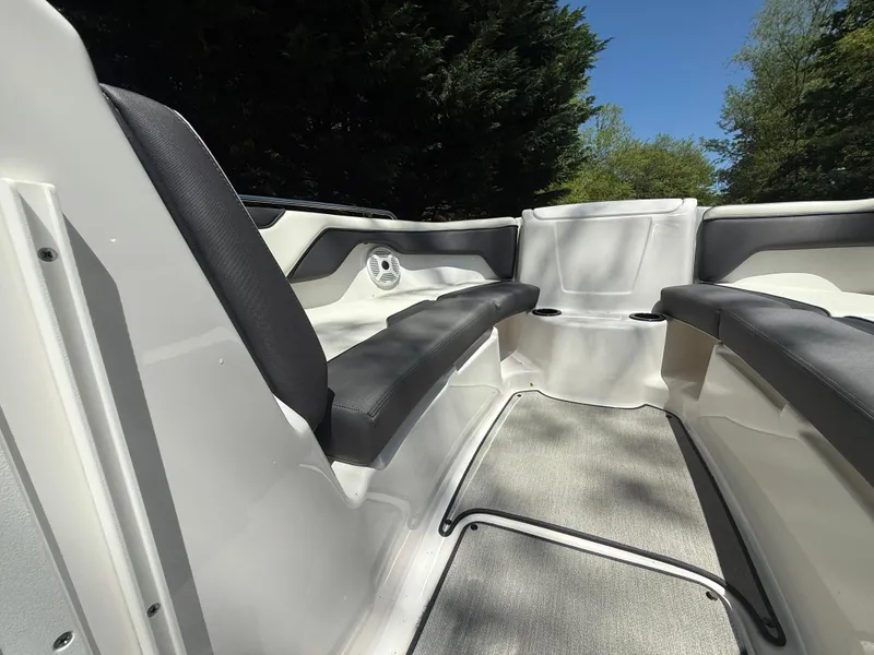 Slide: The Image of 2022 Yamaha AR210 boat interior with black seating and gray flooring. - 22