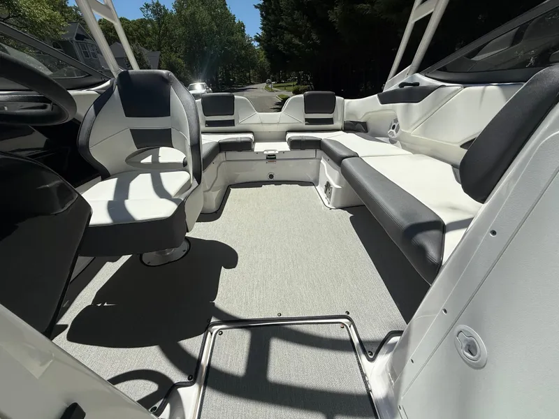 Slide: The Image of 2022 Yamaha Boats AR210 interior with modern seating and sleek design. - 23