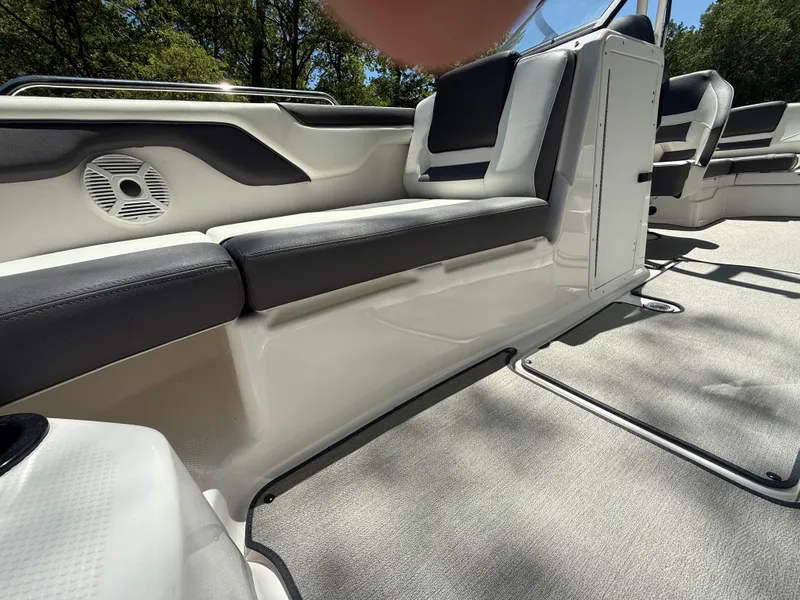 Slide: The Image of 2022 Yamaha AR210 boat interior with sleek seating and speaker system. - 24