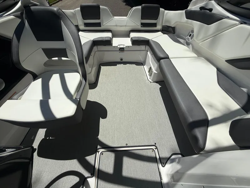 Slide: The Image of 2022 Yamaha AR210 boat interior with gray and white seating arrangement. - 25