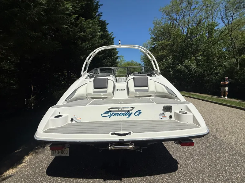 Slide: The Image of 2022 Yamaha AR210 boat on road, rear view, with "Speedy G" text. - 3