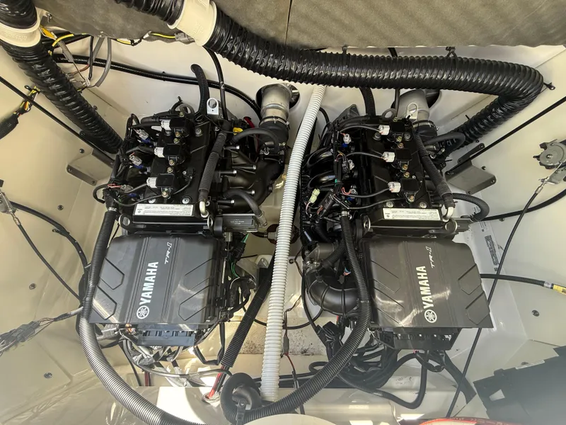 Slide: The Image of 2022 Yamaha AR210 boat engine compartment with dual engines and wiring. - 30